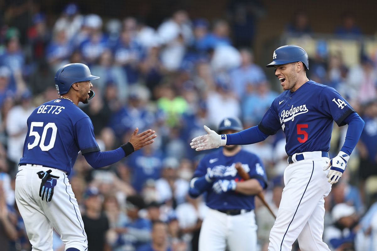Freddie Freeman of the Los Angeles Dodgers celebrates with teammate Mookie Betts #50 after hitting a two-run home run against the Pittsburgh Pirates during the first inning at Dodger Stadium on July 06, 2023 in Los Angeles, California.