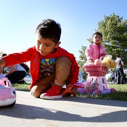Jaden Santos and his sister Kayra play with new toys as families choose from donated shoes, clothes and household items at Copperview Elementary in Midvale on Wednesday, Sept. 18, 2019.