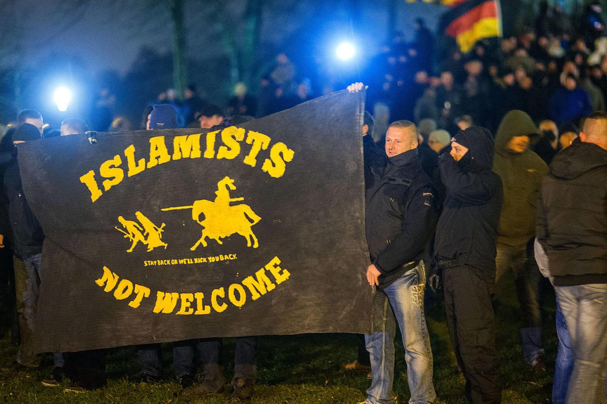Members of the the 'MVgida'  (Mecklenburg-Western Pomerania against the Islamization of the West) anti-Islam movement that is linked to PEGIDA demonstrate with a banner that reads 'Islamists not welcome' in Schwerin, northern Germany, Monday, Jan 12, 2015