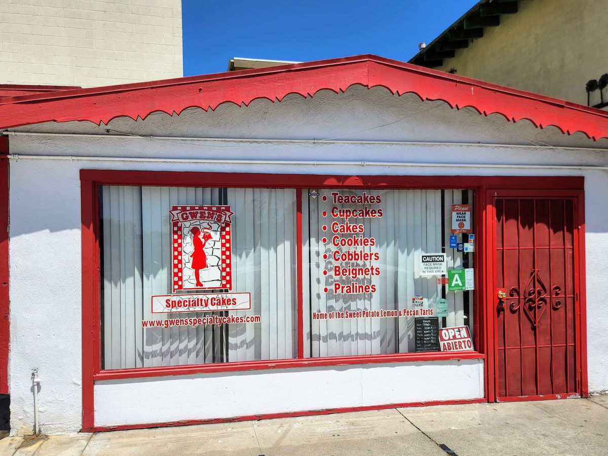A red and white building with a sign that reads Gwen’s Specialty Cakes.