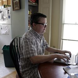 Lee Creighton looks for jobs on the internet at his home in Cary, N.C., Thursday, June 27, 2013. Creighton has been unemployed since October and will receive his last bit of unemployment aid this week. With changes to its unemployment law taking effect this weekend, North Carolina not only is cutting benefits for those who file new claims, it will become the first state disqualified from a federal compensation program for the long-term jobless. (AP Photo/Gerry Broome)