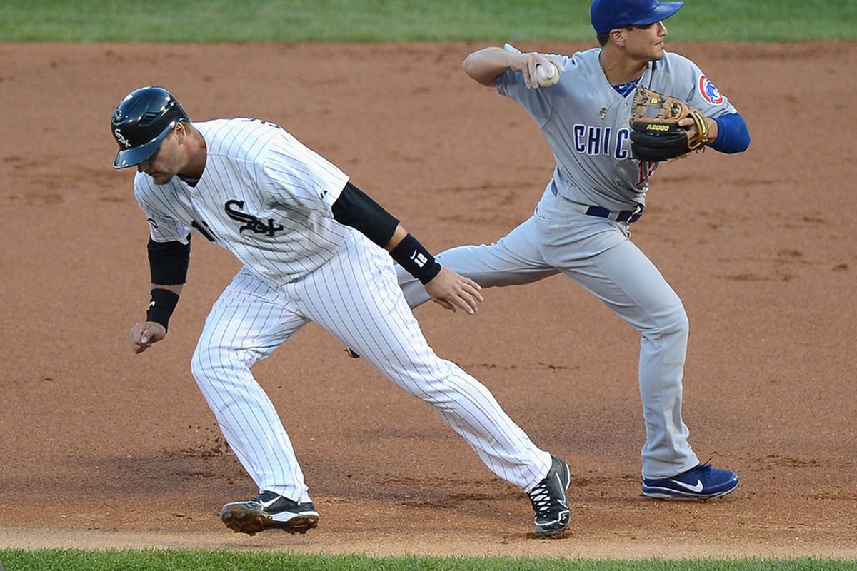 Darwin Barney of the Chicago Cubs throws to first base after tagging out A.J. Pierzynski of the Chicago White Sox in a run-down at U.S. Cellular Field in Chicago, Illinois. (Photo by Jonathan Daniel/Getty Images)