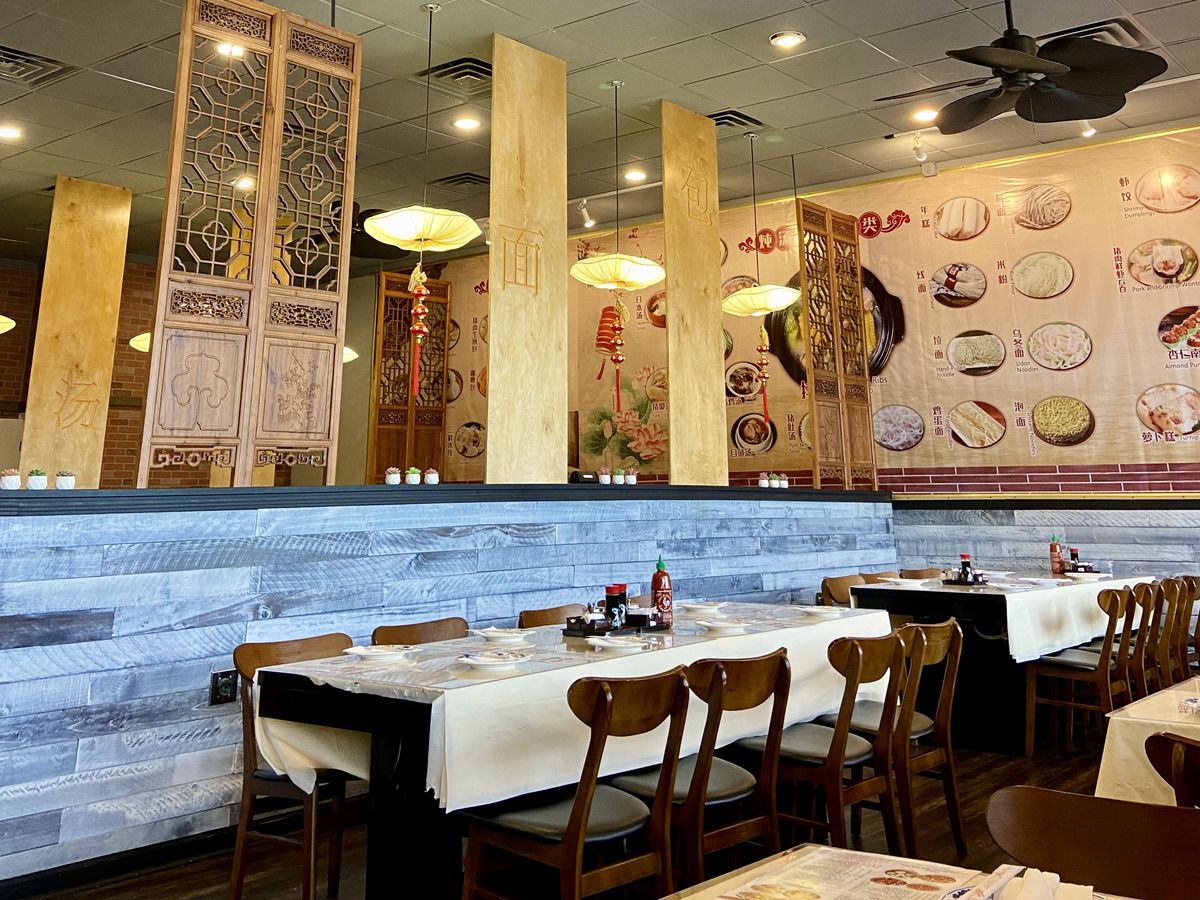 The dining room at The Bun Factory in Doraville, Georgia, which display a variety of dim sum and Chinese dishes on the menu along the back wall. 