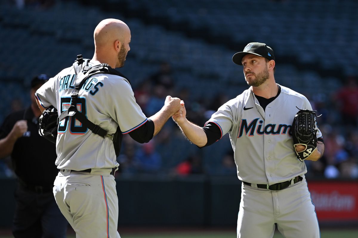 Cole Sulser #31 and Jacob Stallings #58 of the Miami Marlins celebrate an 11-3 win against the Arizona Diamondbacks at Chase Field