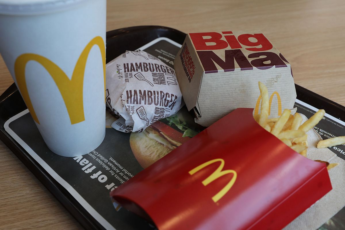A MacDonalds burger, fries, and drink on a tray.