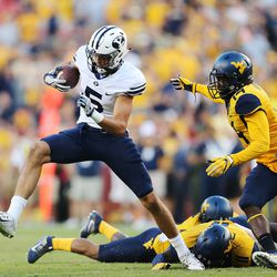 Brigham Young Cougars wide receiver Nick Kurtz (5) looks to run after making a catch with West Virginia Mountaineers cornerback Nana Kyeremeh (14) defending at FedEx Field in Landover, Maryland, Saturday, Sept. 24, 2016.