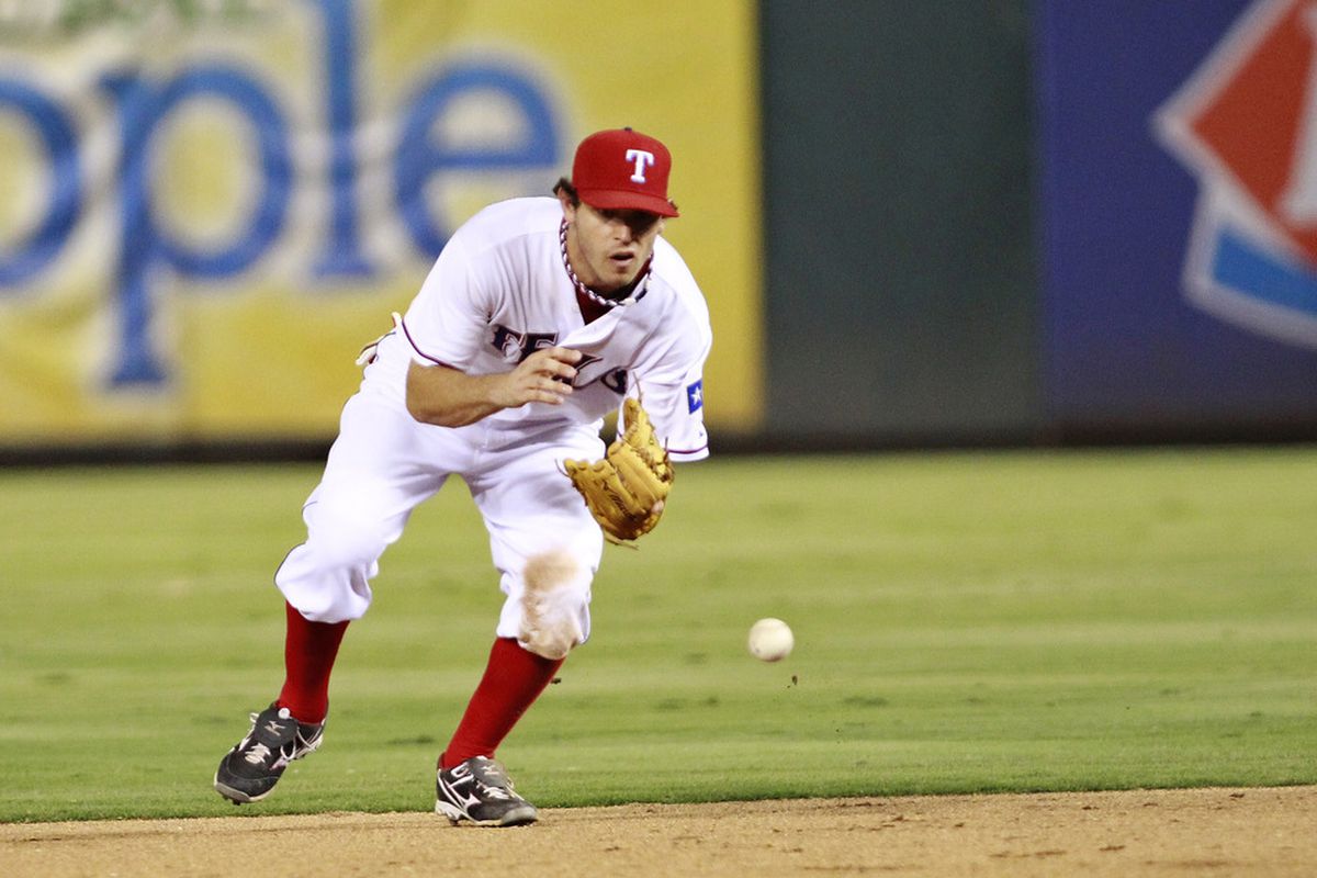 ARLINGTON, TX - JULY 7: Ian Kinsler #5 of the Texas Rangers make the catch and the throw to first base for the out against the Oakland Athletics at Rangers Ballpark in Arlington on July 7, 2011 in Arlington, Texas. (Photo by Rick Yeatts/Getty Images)