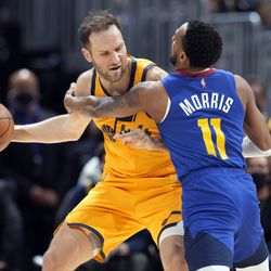 Utah Jazz forward Bojan Bogdanovic, left, looks to pass the ball as Denver Nuggets guard Monte Morris defends in the first half of an NBA basketball game Wednesday, Jan. 5, 2022, in Denver. 