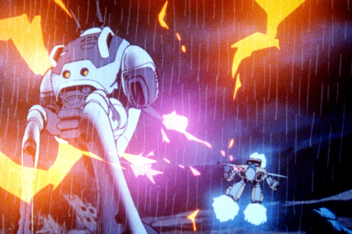 A Robotech mecha fights off an alien 