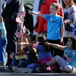 Robert Frost Elementary students show their support as the procession of police vehicles moves down 4100 South en route to the interment of West Valley police officer Cody Brotherson at Valley View Memorial Park in West Valley City on Monday, Nov. 14, 2016.