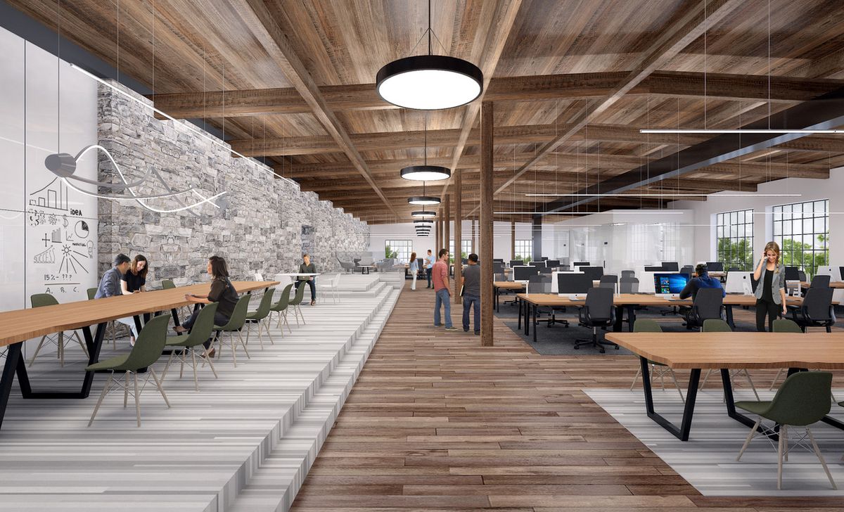 A rendering if the offices’ interior, with original wooden framing, bricks, and flooring mixed with new elements. 