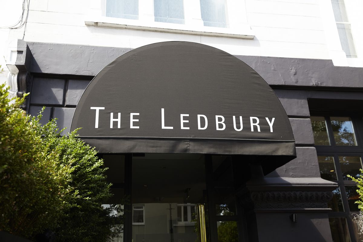 The restaurant signage for the Ledbury in Notting Hill — white capital letters on a grey fabric awning background