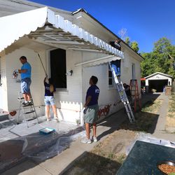 U.S. Bank employees paint a home in Salt Lake City as part of NeighborWorks Salt Lake’s annual Paint Your Heart Out event on Friday, Aug. 11, 2017.