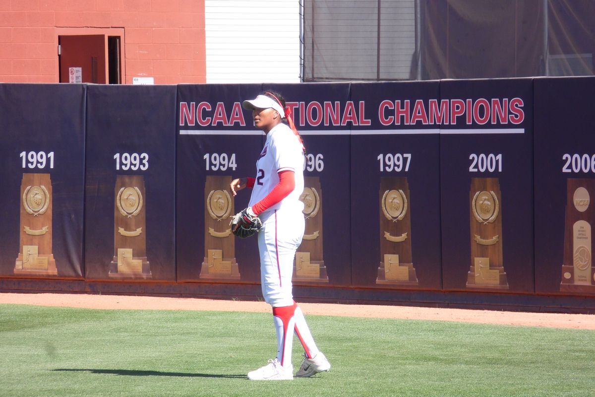 arizona softball outfielder Alexis Dotson stands in front of National Championship logos at Rita Hillenbrand Stadium