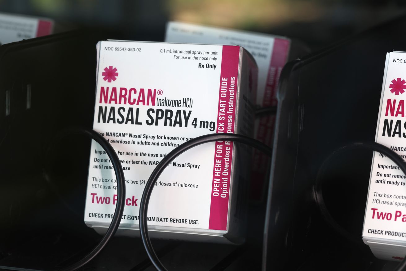 A box of narcan nasal spray in a vending machine.