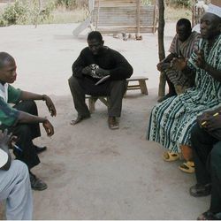 Leaders of the Konkomba people in the north of Ghana listen to a Bible recording in their own language from a device provided by Faith Comes By Hearing.
