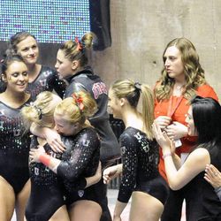 Utah's Georgia Dabritz is congratulated after a perfect score in the vault portion of a contest against UCLA at the Jon M. Huntsman Center on Saturday, Jan. 25, 2014.