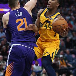 Utah Jazz guard Donovan Mitchell (45) drives around Phoenix Suns center Alex Len (21) in Salt Lake City on Thursday, March 15, 2018. The Jazz 116-88.