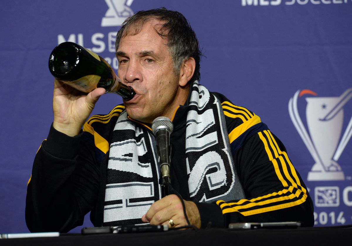  Los Angeles Galaxy head coach Bruce Arena drinks from a bottle of champagne at a press conference after the 2014 MLS Cup final against the New England Revolution at Stubhub Center. 