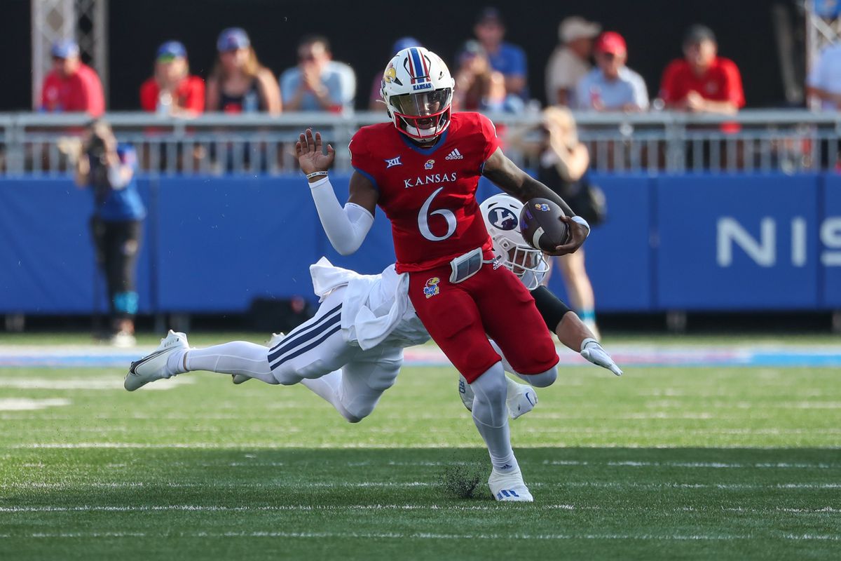 Brigham Young Cougars safety Tanner Wall (28) misses the tackle on Kansas Jayhawks quarterback Jalon Daniels (6) in the third quarter of a Big 12 football game between the Brigham Young Cougars and Kansas Jayhawks on Sep 23, 2023 at David Booth Memorial Stadium in Lawrence, KS.  &nbsp;   