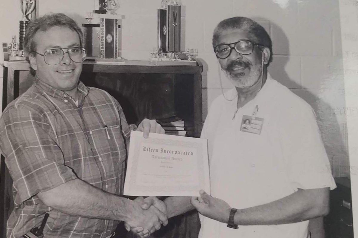 Joe Coleman (right) receives an award from Menard Correctional Center Warden Thomas F. Page.