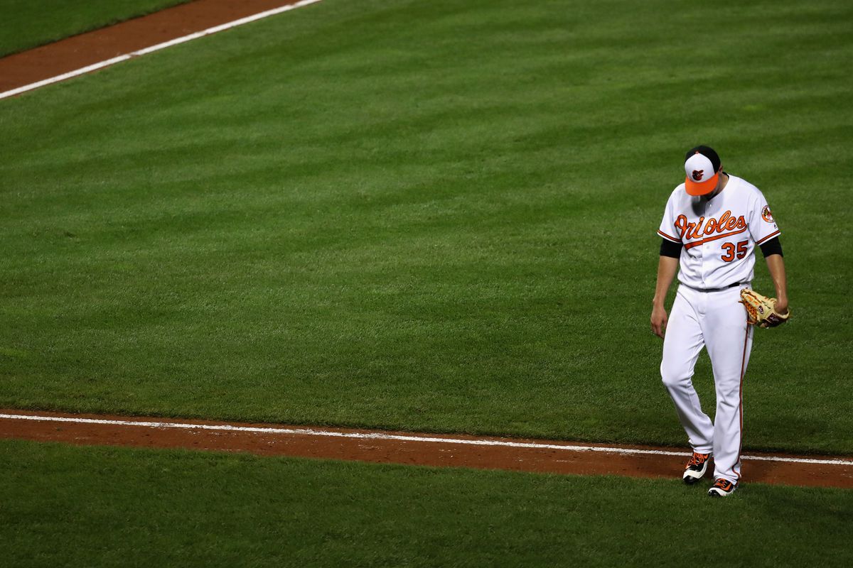 Brad Brach looking dejected after giving up five runs in an Orioles loss to the Red Sox.
