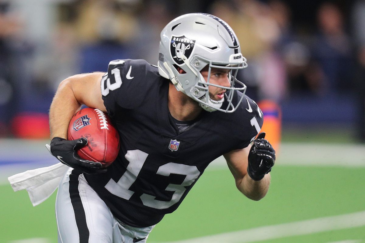 Hunter Renfrow #13 of the Las Vegas Raiders carries the ball after a punt return during the first quarter of the NFL game between Las Vegas Raiders and Dallas Cowboys at AT&amp;T Stadium on November 25, 2021 in Arlington, Texas.