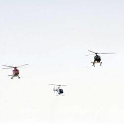 Four helicopters participated in a flyover during the interment service for Utah County Sheriff's Sgt. Cory Wride at the Spanish Fork City Cemetery on Wednesday, Feb. 5, 2014.