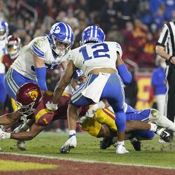 Southern California wide receiver Gary Bryant Jr. (1) dives across the goal line for a touchdown against BYU linebacker Max Tooley (31) and defensive back Malik Moore (12) during the second half of an NCAA college football game in Los Angeles, Saturday, Nov. 27, 2021. 