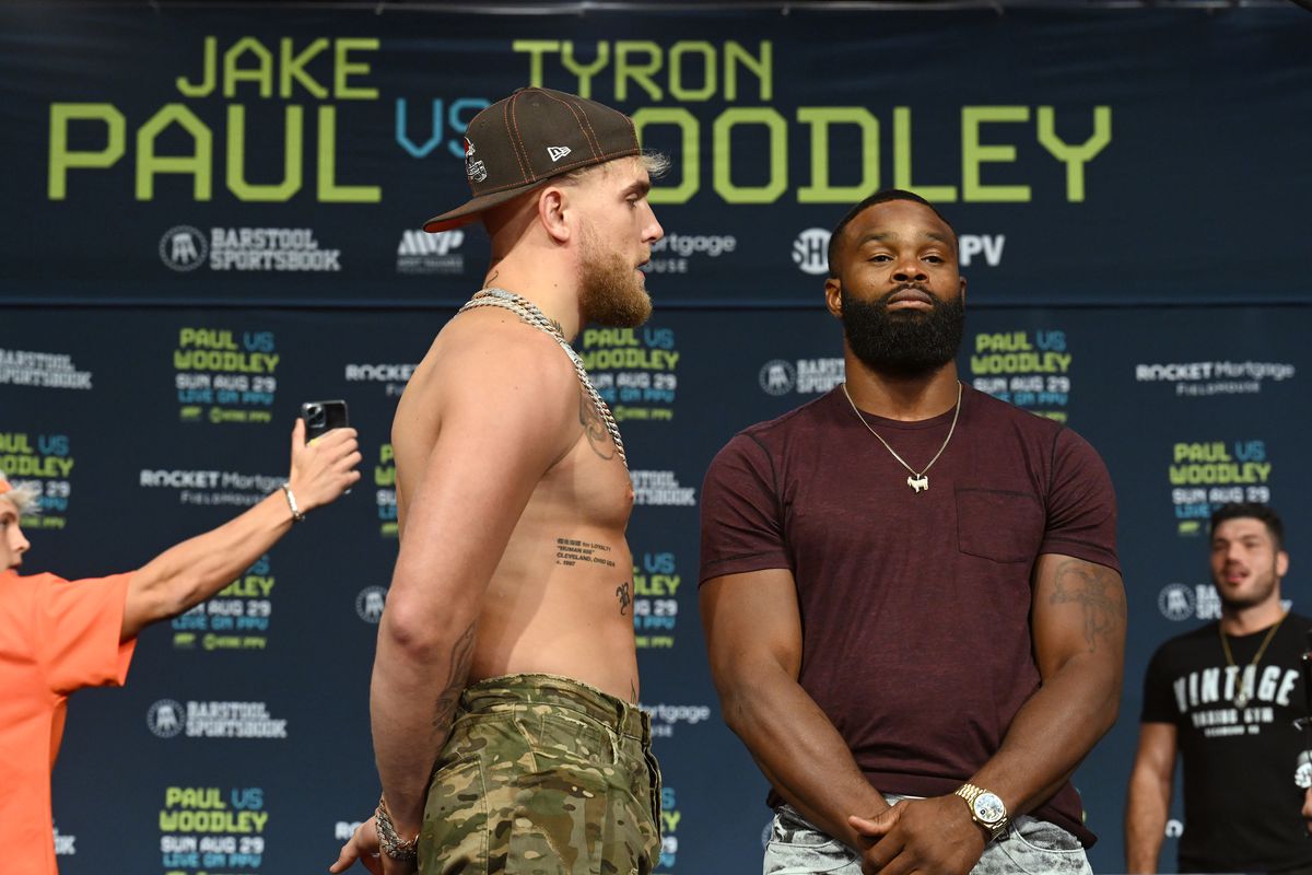 Jake Paul and Tyron Woodley pose during a press conference at the Hilton Cleveland Downtown prior to their August 29 fight on August 26, 2021 in Cleveland, Ohio.