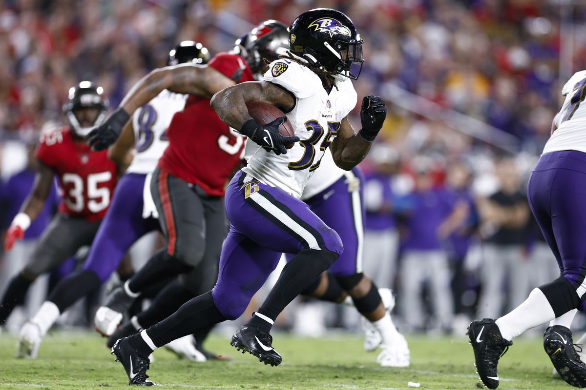 Gus Edwards #35 of the Baltimore Ravens runs with the ball against the Tampa Bay Buccaneers during the fourth quarter at Raymond James Stadium on October 27, 2022 in Tampa, Florida.