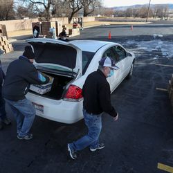 Volunteers from The Church of Jesus Christ of Latter-day Saints load food boxes into the cars of Native Americans on the Fort Hall Reservation in Idaho on Monday, Feb. 1, 2021.