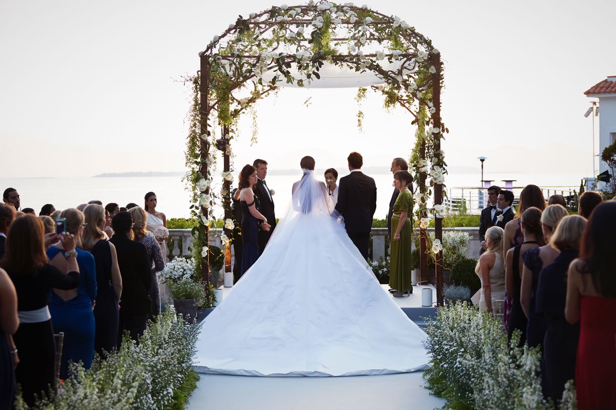 Nell and Teddy stand under the wedding huppah during the ceremony, which overlooks the Mediterranean Sea.
