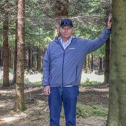 Ken Evans poses for a photo near the site where his father was shot down on Dec. 24, 1944, during the Battle of the Bulge within the Ardennes Forest.