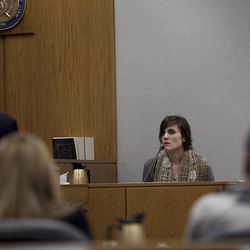 Rachel MacNeill, daughter of defendant Martin MacNeill, speaks to prosecutor Chad Grunander, left, during a preliminary hearing at the Fourth District Court in Provo Wednesday, Oct. 10, 2012. 