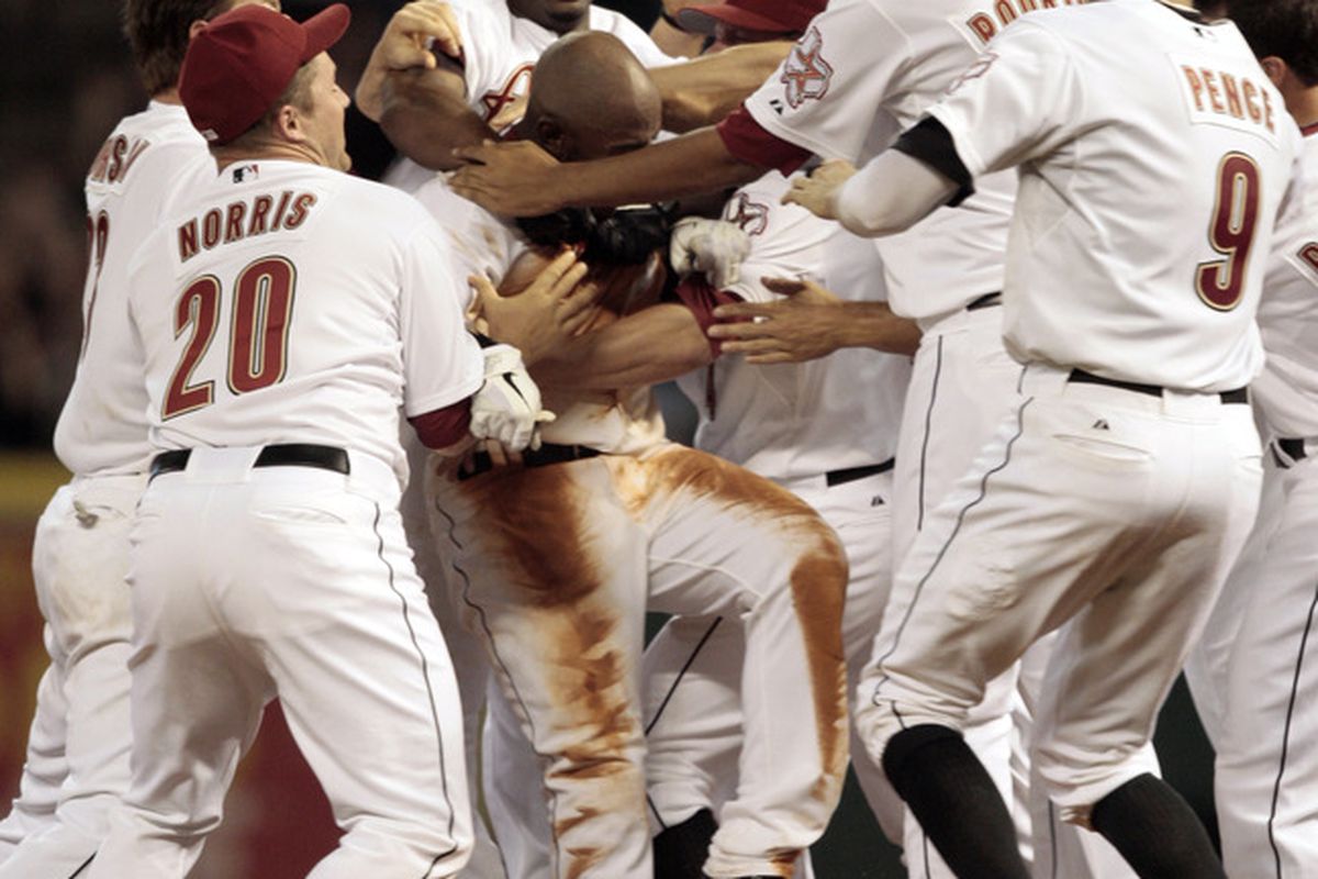 Jason Bourgeois is mobbed by his teammates after a walk-off win last week. (Photo by Bob Levey/Getty Images)