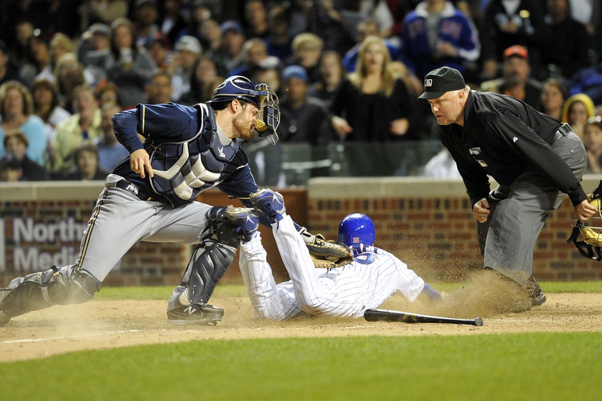 Darwin Barney of the Chicago Cubs scores the winning run as Wil Nieves of the Milwaukee Brewers makes the tag on June 13, 2011 at Wrigley Field in Chicago, Illinois. The Cubs defeated the Brewers 1-0. (Photo by David Banks/Getty Images)