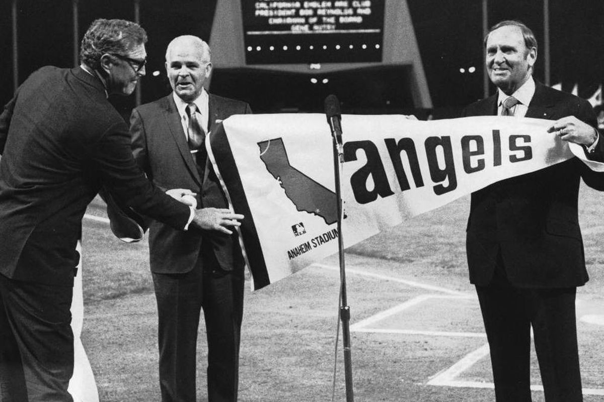 Mayor Jack Dutton, at center, accepting the new California Angels pennant from club owner, Gene Autry, at right and club president, Robert Reynolds, at left.