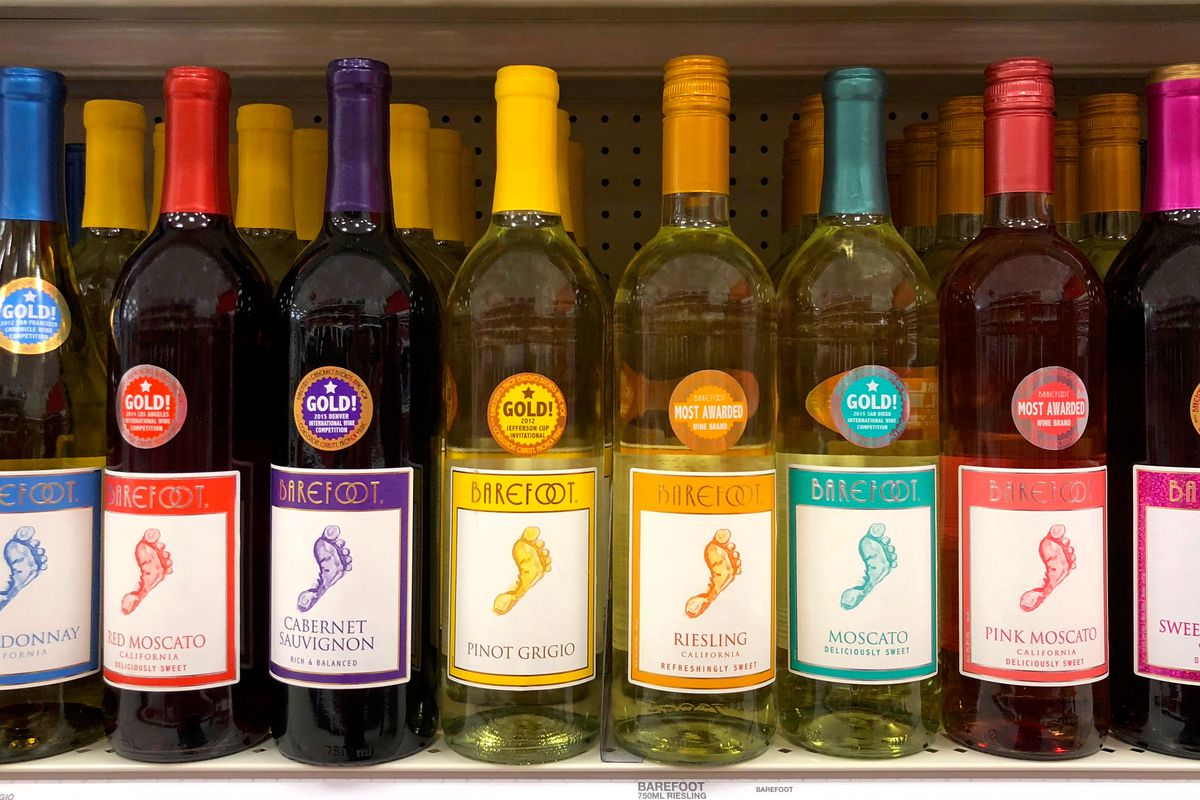 a row of wine bottles in different colors with labels that say barefoot