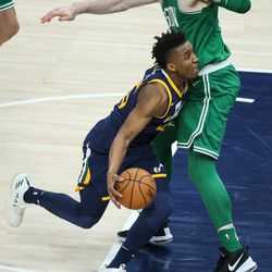 Utah Jazz guard Donovan Mitchell (45) drives against Boston Celtics center Aron Baynes (46) at Vivint Smart Home Arena in Salt Lake City on Wednesday, March 28, 2018.