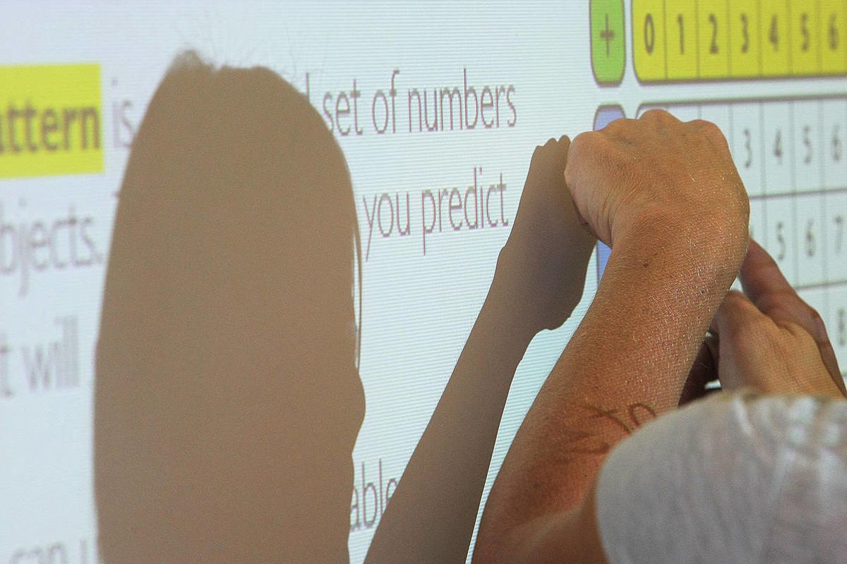A third-grade teacher teaches math to her students Monday, Aug. 25, 2014.