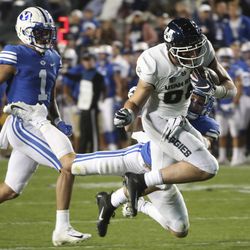 Brigham Young Cougars linebacker Zayne Anderson (23) makes a touchdown saving tackle on Utah State Aggies tight end Carson Terrell (88) during the Utah State versus BYU football game at LaVell Edwards Stadium in Provo on Friday, Oct. 5, 2018.
