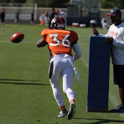 Denver Broncos CB Keyvon Webster reaches to swat an attempted pass during drills at training camp.