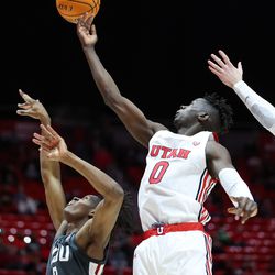 Utah Utes center Lahat Thioune (0) lays the ball up over Washington State Cougars forward Efe Abogidi (0) during the game at the Huntsman Center in Salt Lake City on Saturday, Jan. 8, 2022.