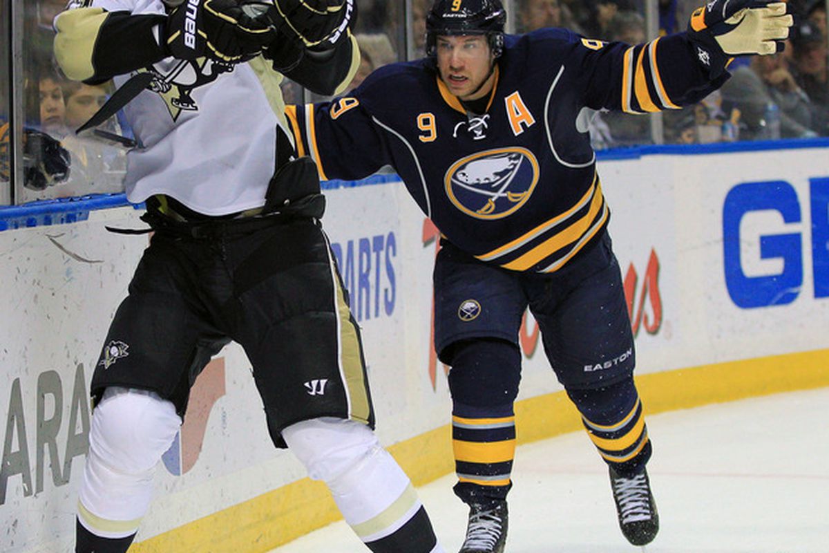 Mar 30, 2012; Buffalo, NY, USA; Buffalo Sabres center Derek Roy (9) gets called for hooking on Pittsburgh Penguins center Evgeni Malkin (71) during the second period at the First Niagara Center. Mandatory Credit: Kevin Hoffman-US PRESSWIRE