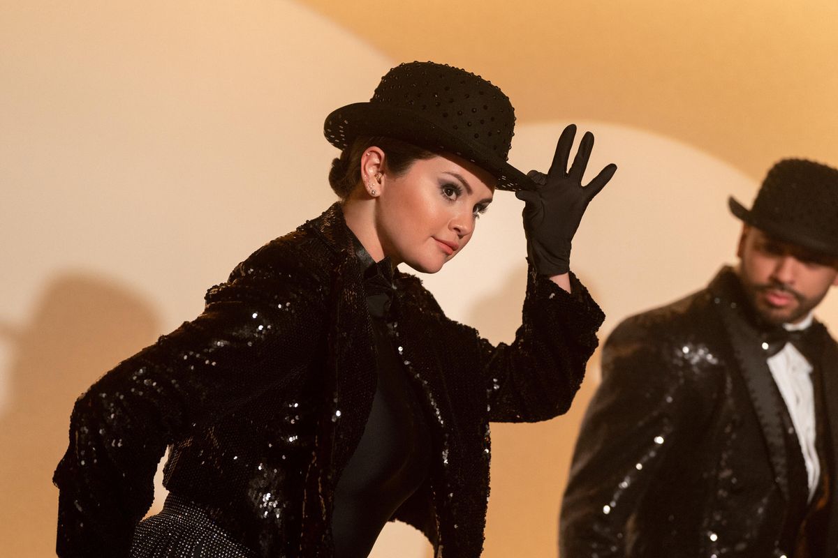 Selena Gomez wears a rhinestone jacket and bowler hat she tips in a dream dance number from Only Murders in the Building Season 3