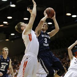 BYU's Tyler Haws, right, shoots under pressure by Pepperdine's David Jesperson during the first half of an NCAA college basketball game Thursday, Feb. 5, 2015, in Malibu, Calif.