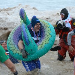 Participants jump into a 34-degree Lake Michigan for the Chicago Polar Plunge. | Victor Hilitski/For the Sun-Times