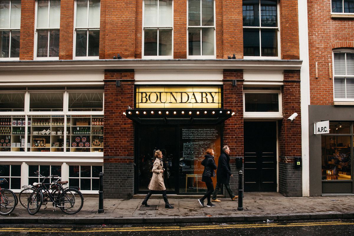 A woman and a couple walk past the Boundary hotel in Shoreditch