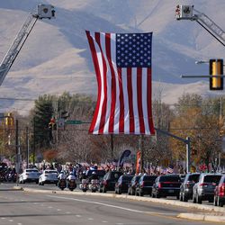 A motorcade escorts the casket of West Valley police officer Cody Brotherson, en route to his interment at Valley View Memorial Park in West Valley City on Monday, Nov. 14, 2016.